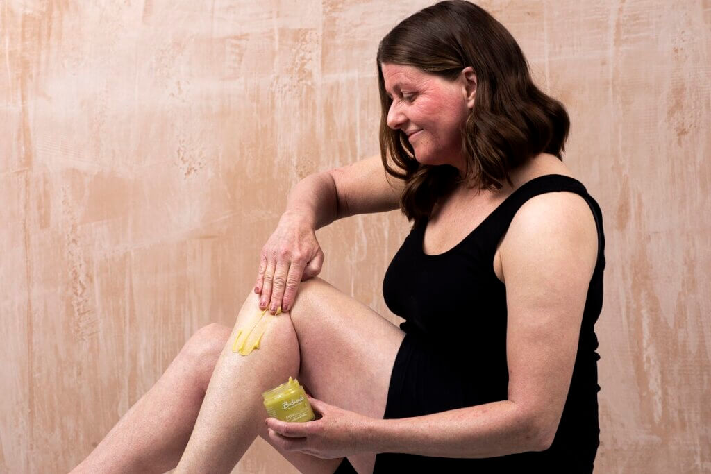 Balmonds skin salvation being shown on legs of lady with eczema